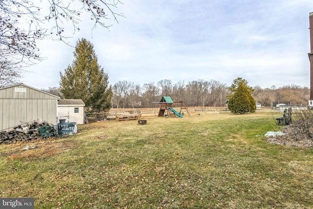 view of yard featuring a shed and a playground