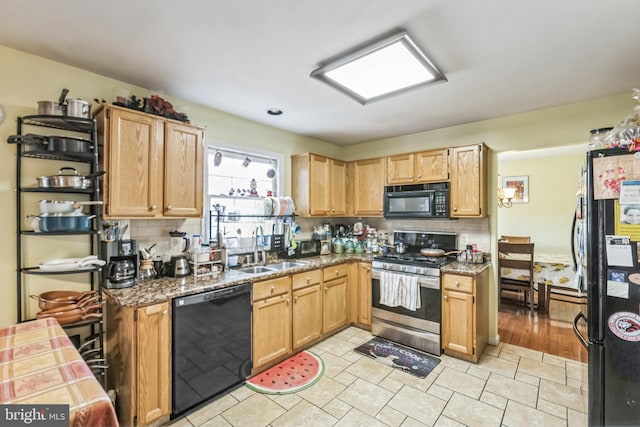 kitchen with tasteful backsplash, sink, and black appliances