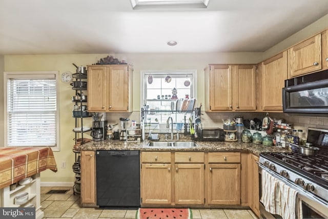 kitchen with sink, backsplash, black appliances, and dark stone counters