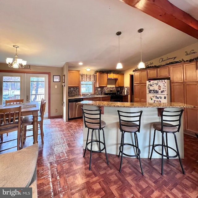 kitchen with dark parquet flooring, a center island, hanging light fixtures, stainless steel appliances, and backsplash