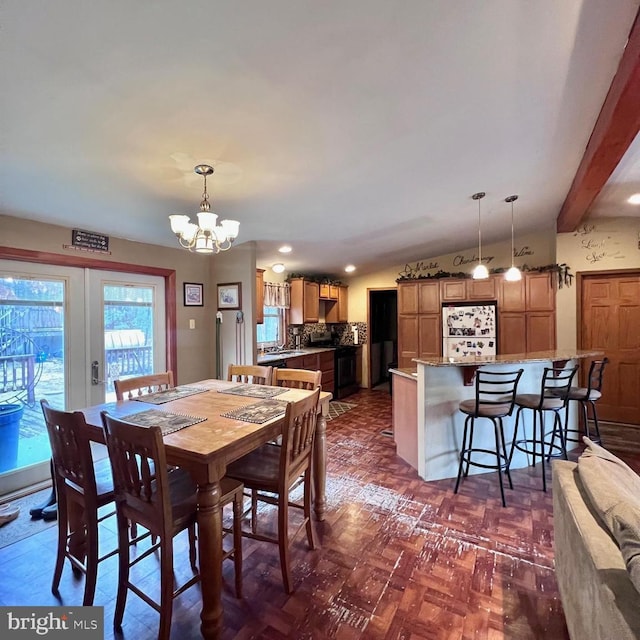 dining area featuring an inviting chandelier, beam ceiling, dark parquet floors, and french doors