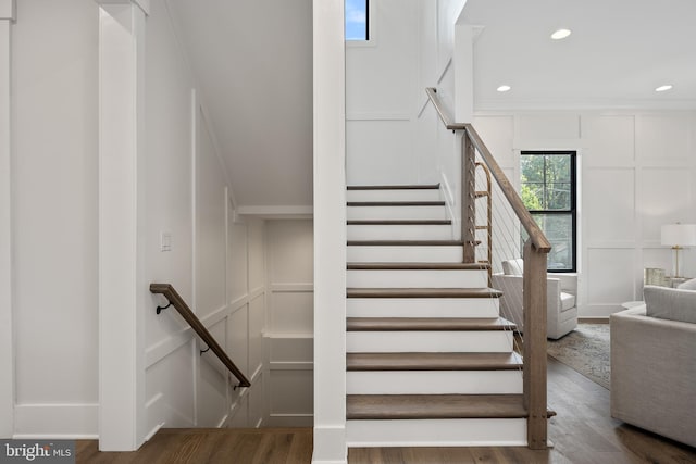 staircase with hardwood / wood-style flooring