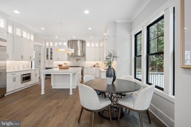 dining area with crown molding, wine cooler, and dark hardwood / wood-style flooring