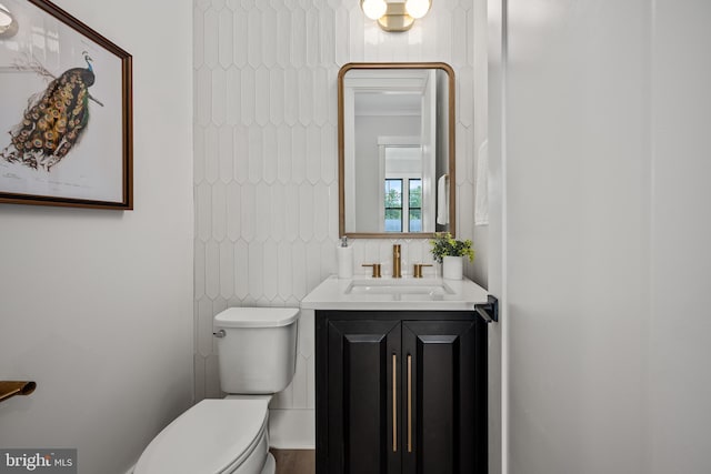 bathroom featuring vanity, backsplash, tile walls, and toilet