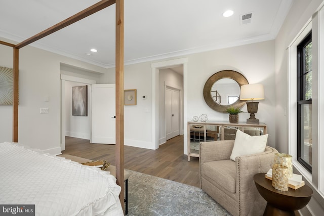 bedroom with hardwood / wood-style flooring and crown molding