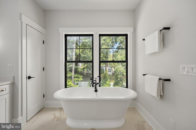 bathroom with vanity and a tub to relax in