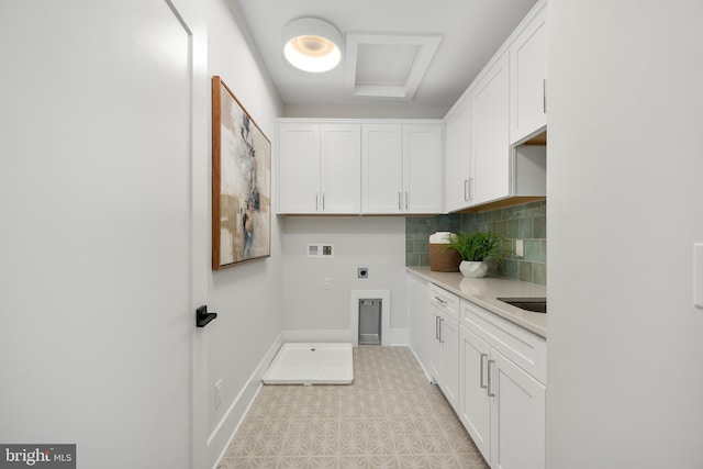 clothes washing area with cabinets, washer hookup, and hookup for an electric dryer