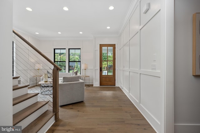 entrance foyer with hardwood / wood-style flooring and ornamental molding