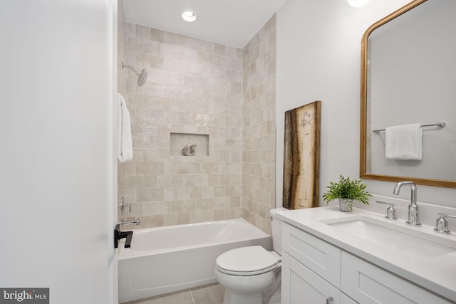 full bathroom featuring tiled shower / bath combo, vanity, tile patterned floors, and toilet