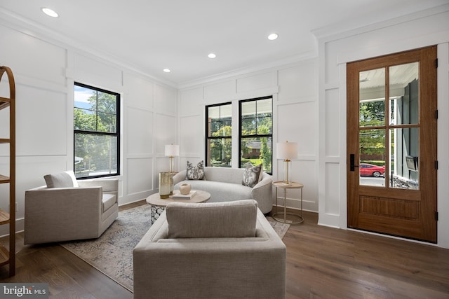 living room with ornamental molding, dark hardwood / wood-style floors, and a wealth of natural light