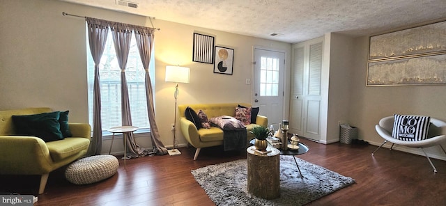 sitting room with dark hardwood / wood-style flooring and a textured ceiling