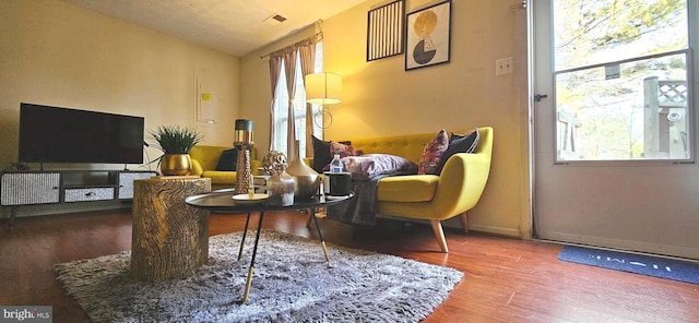 sitting room featuring vaulted ceiling and hardwood / wood-style floors