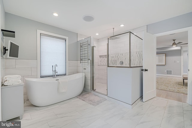 bathroom with independent shower and bath, tile walls, and ceiling fan