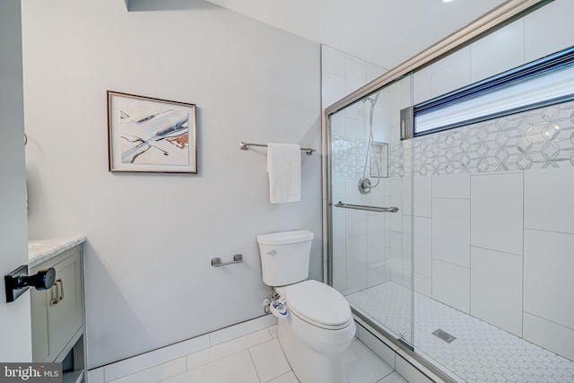 bathroom featuring tile patterned floors, toilet, an enclosed shower, and vanity