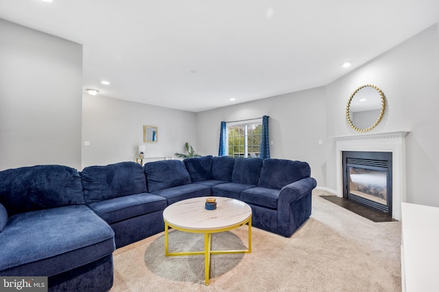 carpeted living room featuring a fireplace with flush hearth and recessed lighting