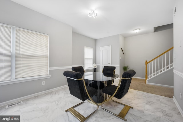 interior space with marble finish floor, baseboards, stairs, and visible vents