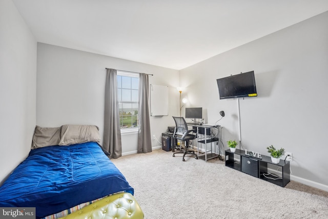 carpeted bedroom featuring baseboards