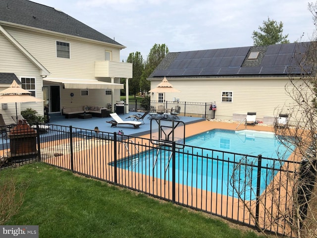 view of pool with an outdoor living space and a patio area