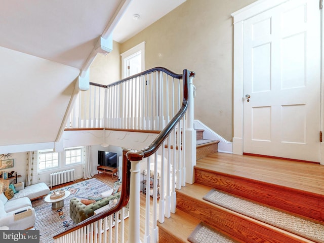 stairway featuring wood-type flooring and radiator