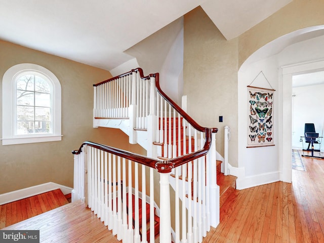 stairs featuring hardwood / wood-style floors