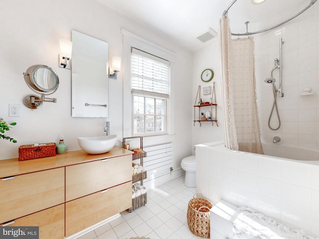 full bathroom with shower / tub combo with curtain, tile patterned floors, toilet, and vanity