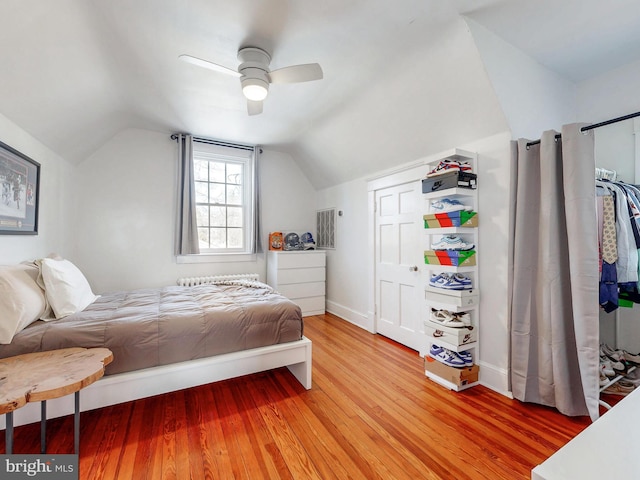 bedroom with wood-type flooring, vaulted ceiling, and ceiling fan