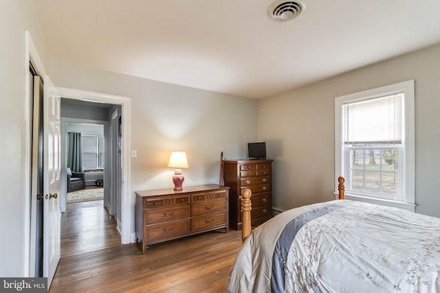 bedroom with dark hardwood / wood-style floors