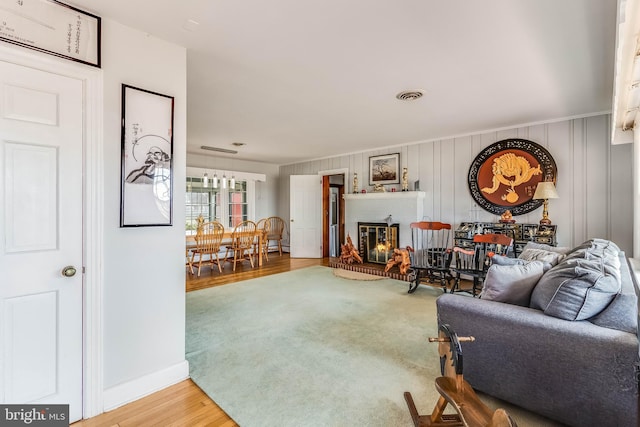 living room with a brick fireplace and hardwood / wood-style floors