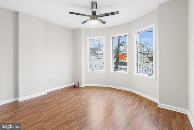 unfurnished room featuring hardwood / wood-style floors and ceiling fan