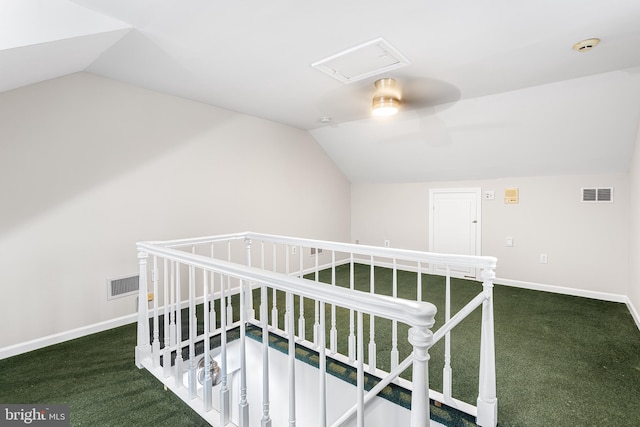 hall with vaulted ceiling and carpet