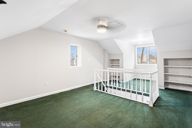 carpeted bedroom with vaulted ceiling and ceiling fan