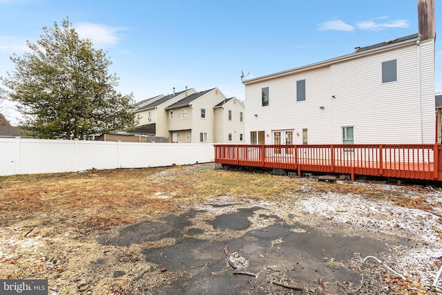 rear view of property featuring a deck