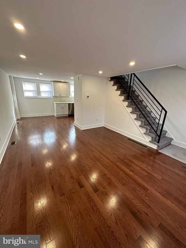 unfurnished living room with dark hardwood / wood-style flooring