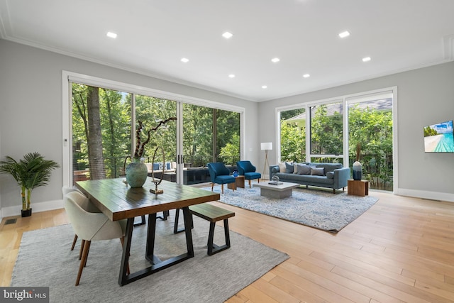 living room with ornamental molding and light wood-type flooring