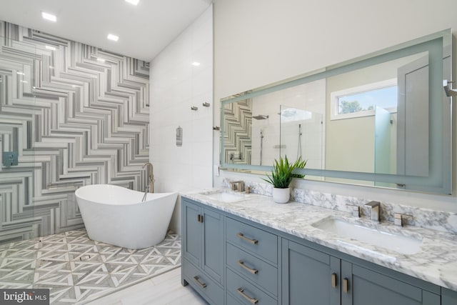 bathroom featuring tile walls, vanity, and shower with separate bathtub