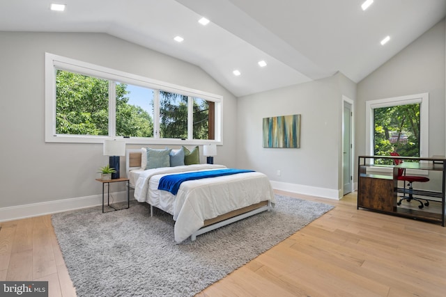 bedroom with lofted ceiling and light hardwood / wood-style flooring