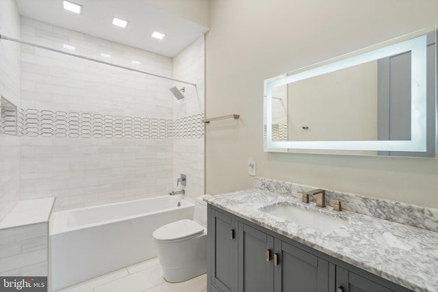 full bathroom featuring vanity, toilet, and tiled shower / bath combo