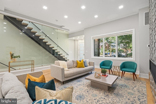 living room featuring crown molding and light hardwood / wood-style flooring