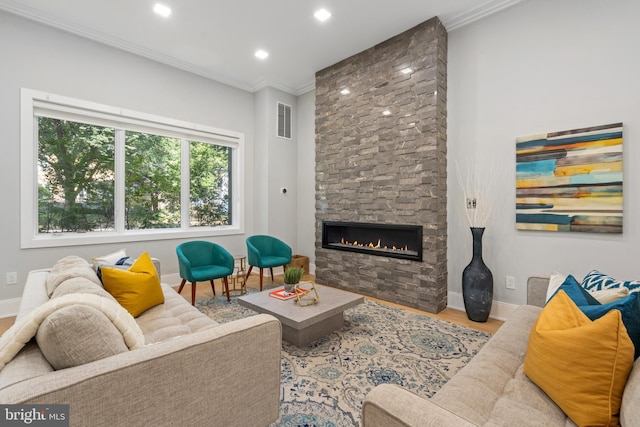 living room with crown molding, hardwood / wood-style floors, and a fireplace