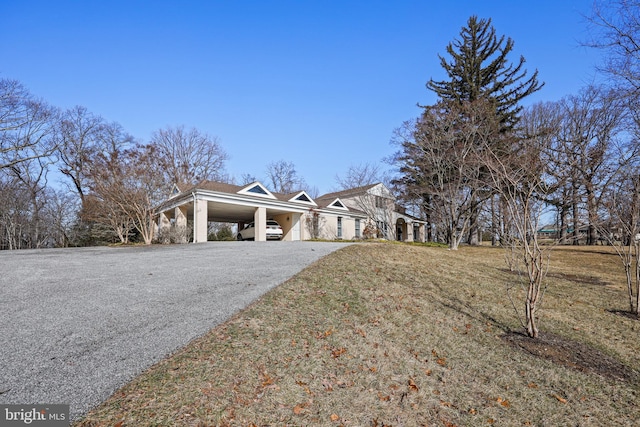 view of side of property with a yard and a carport