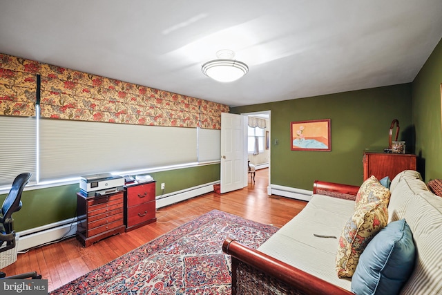 living room featuring light hardwood / wood-style flooring and a baseboard heating unit