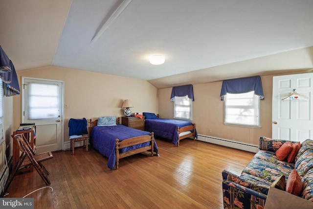 bedroom featuring baseboard heating, wood-type flooring, vaulted ceiling, and multiple windows