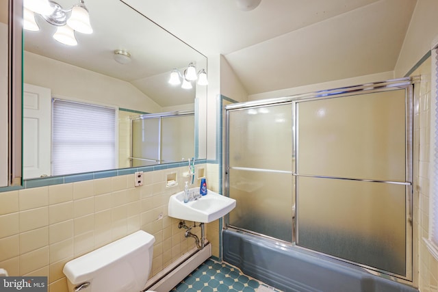 full bathroom with lofted ceiling, sink, shower / bath combination with glass door, tile walls, and toilet