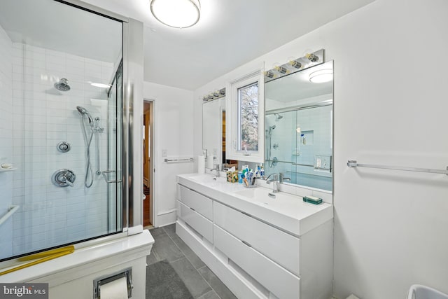 bathroom featuring vanity and a shower with shower door