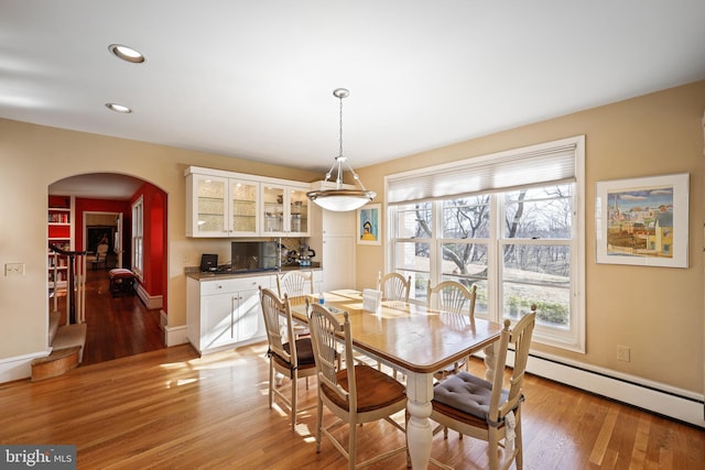 dining space featuring light hardwood / wood-style flooring and baseboard heating