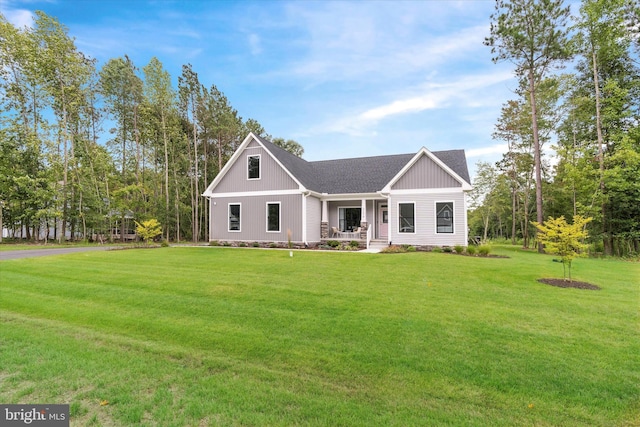 craftsman-style home featuring covered porch and a front lawn