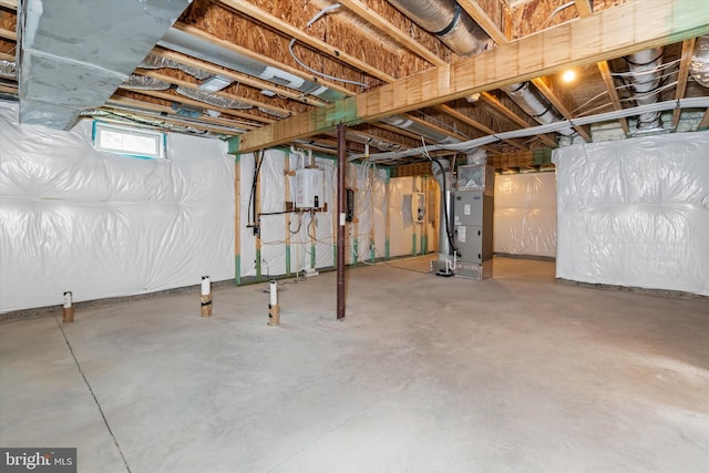 basement featuring tankless water heater and heating unit