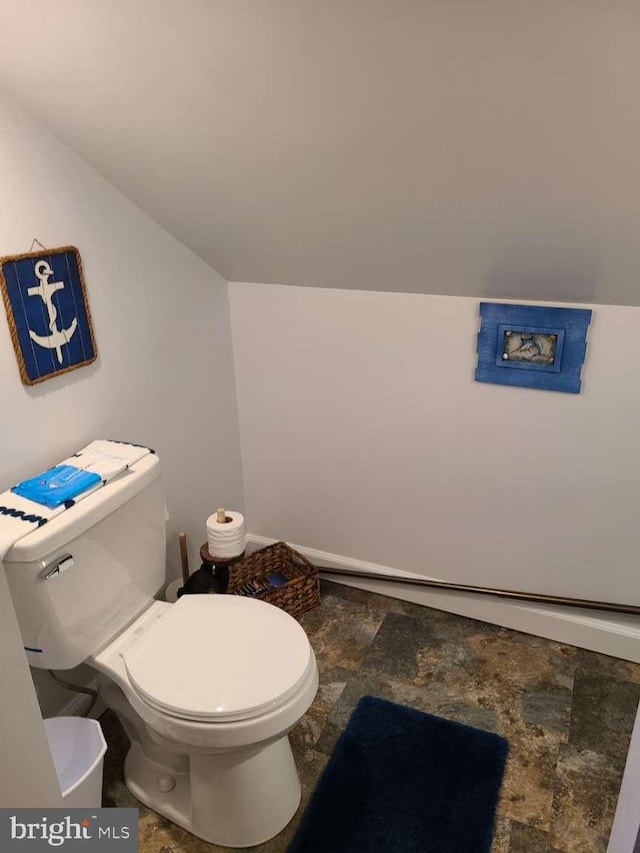 bathroom with toilet and vaulted ceiling