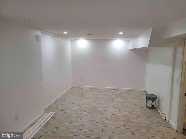 finished basement featuring baseboards, wood finish floors, and recessed lighting