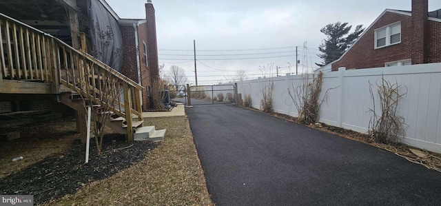 view of street featuring stairs and a gated entry